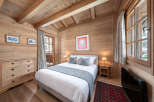 This cozy bedroom features a warm wooden interior, creating a rustic and inviting atmosphere.