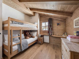 This charming bedroom features a cozy bunk bed, perfect for a family or guests.