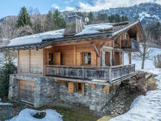 Discover the charm of this stunning wooden chalet nestled in a picturesque mountain setting.