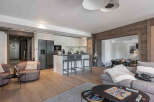 This stunning property features a modern kitchen with sleek cabinetry and a breakfast bar, perfect for entertaining.