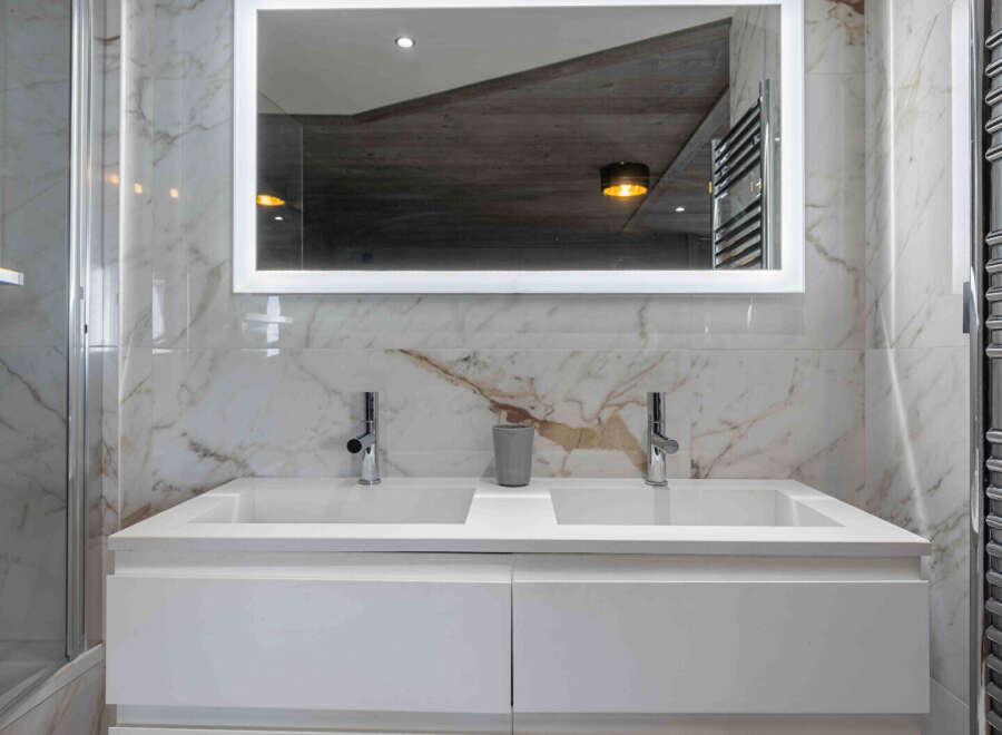 This stunning bathroom boasts a modern design with luxurious marble finishes.