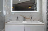 This stunning bathroom boasts a modern design with luxurious marble finishes.