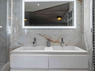 This stunning bathroom boasts a modern design with luxurious marble finishes.