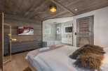 Experience luxury living in this stunning bedroom featuring a modern design and rustic charm.