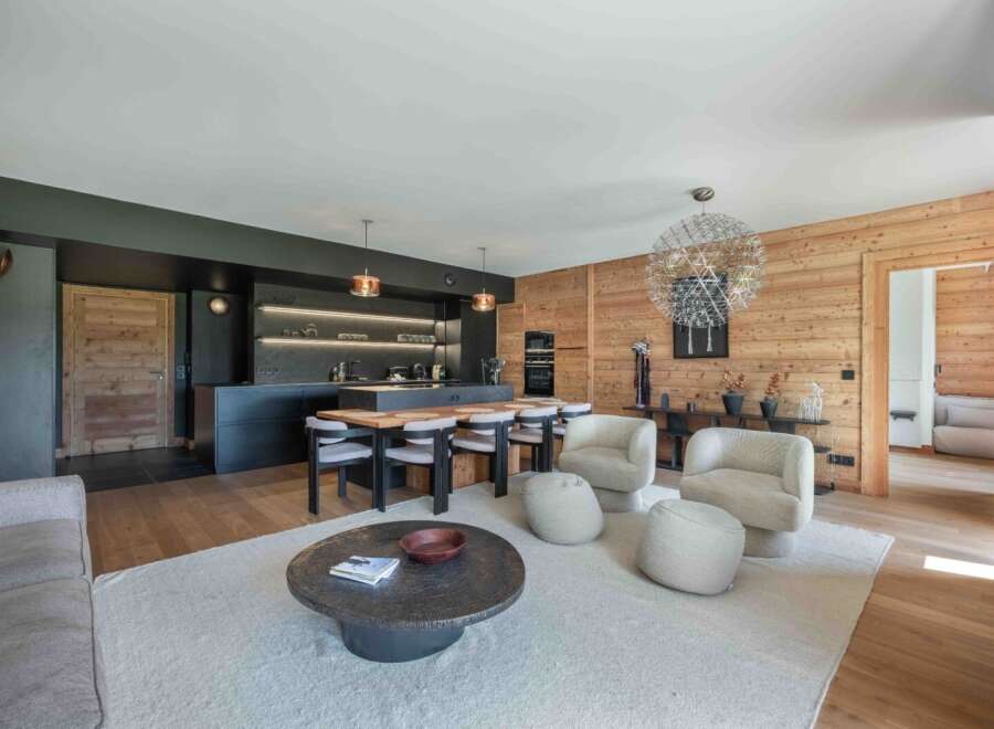 Experience luxury living in this stunning property, featuring a modern kitchen with sleek black cabinetry and a spacious island perfect for entertaining.