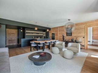 Experience luxury living in this stunning property, featuring a modern kitchen with sleek black cabinetry and a spacious island perfect for entertaining.
