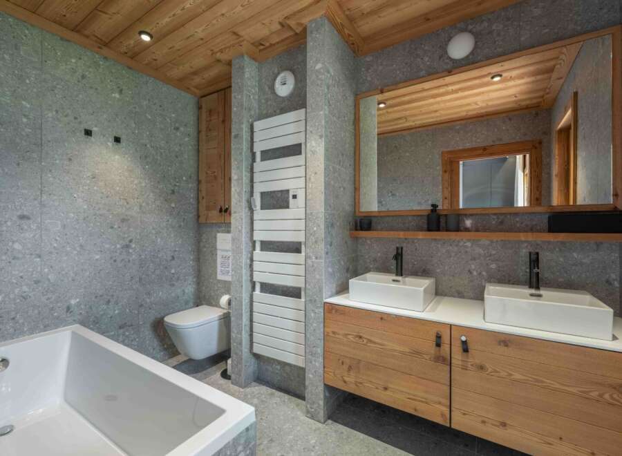 This stunning bathroom features a modern design with a touch of rustic charm.