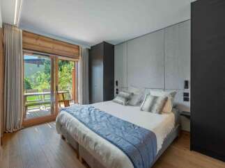 Experience luxury in this stunning bedroom featuring a king-size bed, elegant headboard, and a private balcony.