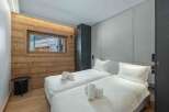 This cozy bedroom features two twin beds with crisp white linens and plush pillows, perfect for a comfortable stay.