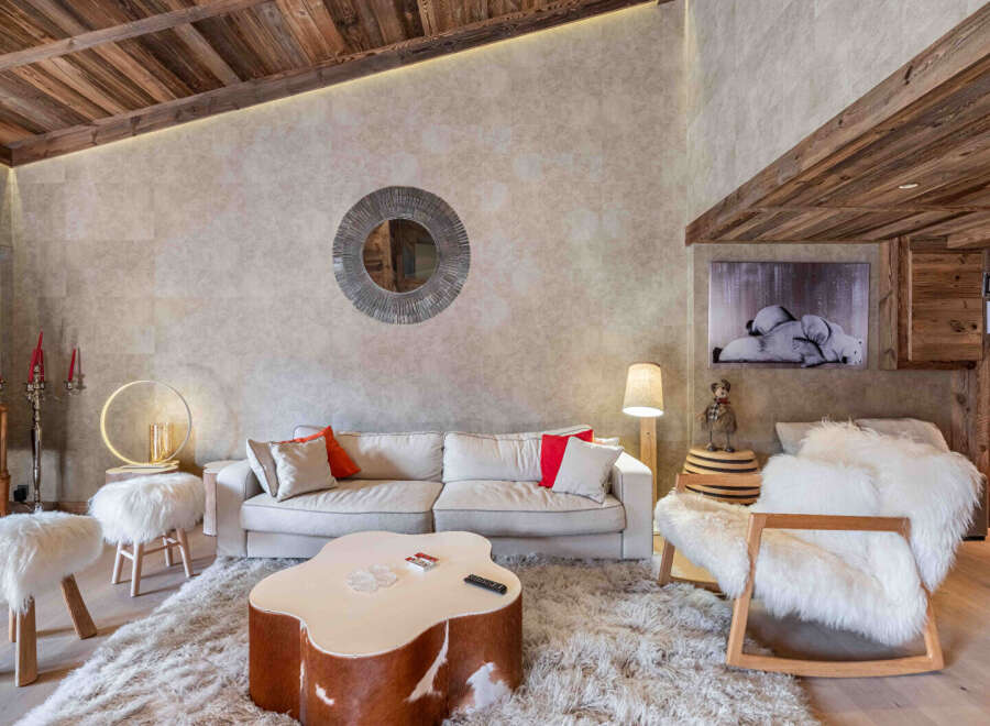 Experience luxury living in this stunning property, featuring a cozy living room with a plush rug and a unique coffee table.