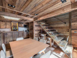 This stunning property boasts a warm and inviting interior with exquisite wooden accents throughout.