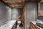 This stunning bathroom showcases a rustic design with wooden accents.
