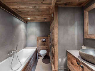 This stunning bathroom showcases a rustic design with wooden accents.