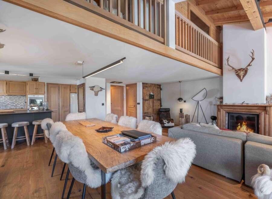 Experience rustic elegance in this stunning property, featuring a cozy fireplace and a spacious dining area perfect for gatherings.
