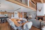Experience rustic elegance in this stunning property, featuring a cozy fireplace and a spacious dining area perfect for gatherings.