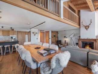 Experience rustic elegance in this stunning property, featuring a cozy fireplace and a spacious dining area perfect for gatherings.