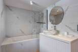 Step into a luxurious bathroom oasis, featuring stunning marble-effect tiles that exude elegance.
