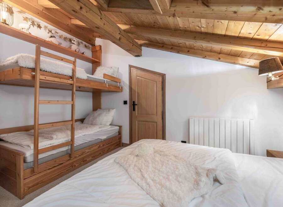 This cozy bedroom features a unique bunk bed setup, perfect for families or groups.