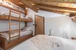 This cozy bedroom features a unique bunk bed setup, perfect for families or groups.