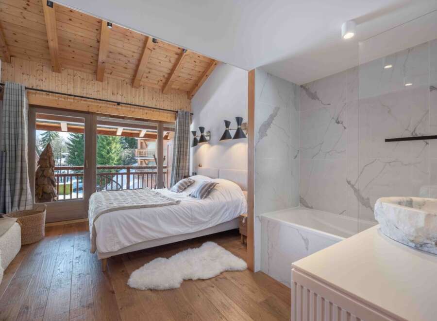 Experience luxury in this stunning bedroom featuring a cozy bed, a plush rug, and a beautiful view.