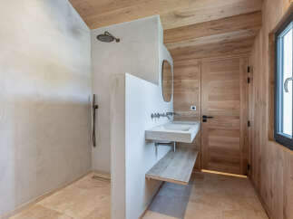This stunning bathroom boasts a modern design with natural wood accents, creating a warm and inviting atmosphere.