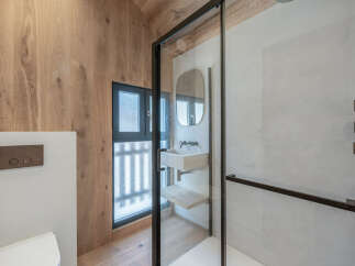 Step into a modern bathroom oasis, featuring a sleek glass shower enclosure and a stylish vanity.