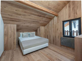 This cozy bedroom features a stunning wooden interior, creating a warm and inviting atmosphere.