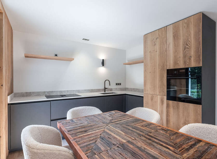 This modern kitchen boasts a stylish design with wooden cabinetry and sleek countertops.