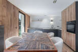 This stunning kitchen and dining area boasts a modern design with a touch of rustic charm.