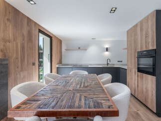 This stunning kitchen and dining area boasts a modern design with a touch of rustic charm.