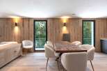 This stunning property boasts a modern dining area with a beautiful wooden table and comfortable chairs, perfect for hosting gatherings.