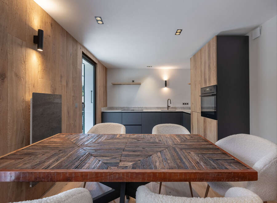 This stunning kitchen and dining area boasts a unique blend of modern and rustic design.