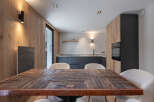 This stunning kitchen and dining area boasts a unique blend of modern and rustic design.