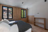 This stunning bedroom boasts a modern design with natural wood accents, creating a warm and inviting atmosphere.