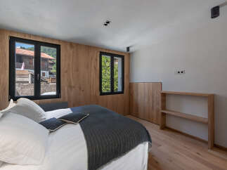 This stunning bedroom boasts a modern design with natural wood accents, creating a warm and inviting atmosphere.