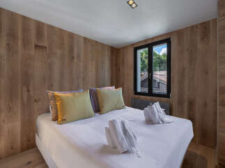 This cozy bedroom features a comfortable bed with soft pillows and fresh towels.