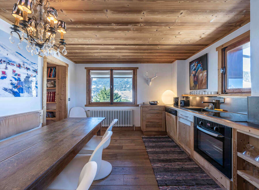 This stunning kitchen boasts a rustic charm with its wooden ceiling and cabinetry, creating a warm and inviting atmosphere.