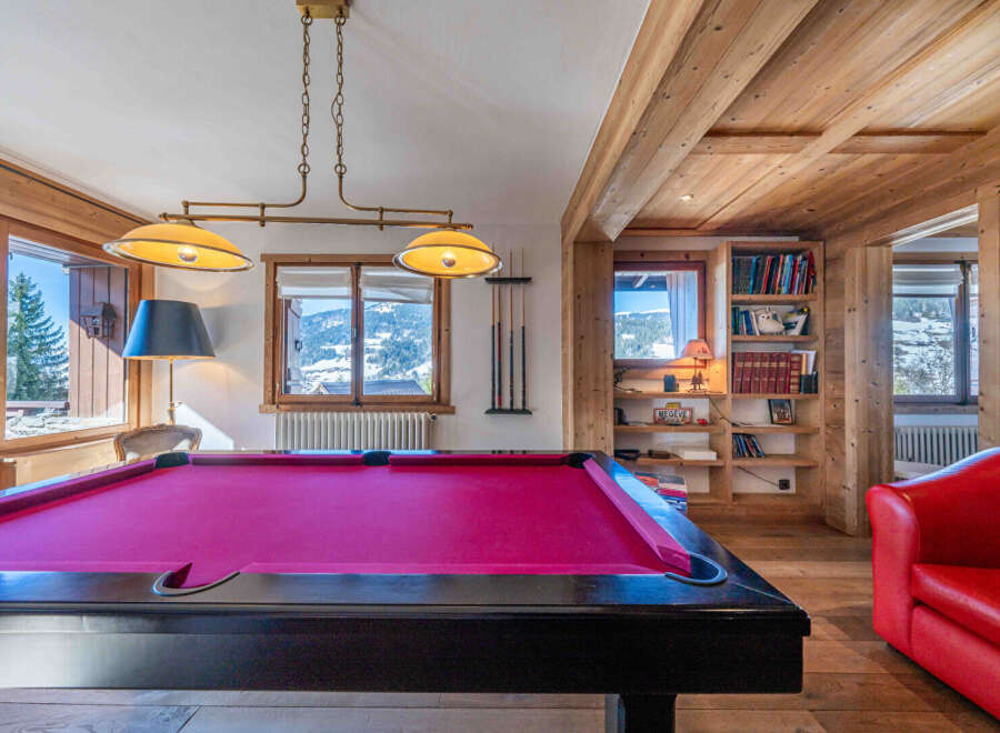 Experience luxury living in this stunning property featuring a vibrant pool table, perfect for entertaining guests.