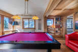 Experience luxury living in this stunning property featuring a vibrant pool table, perfect for entertaining guests.