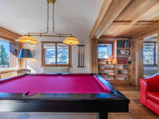 Experience luxury living in this stunning property featuring a vibrant pool table, perfect for entertaining guests.