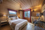 Experience the warmth and charm of this cozy bedroom, featuring stunning wood paneling throughout.