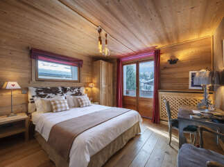 Experience the warmth and charm of this cozy bedroom, featuring stunning wood paneling throughout.