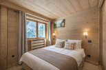 This cozy bedroom features a warm, inviting atmosphere with its wooden walls and ceiling.