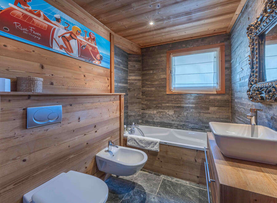 This stunning bathroom boasts a unique blend of rustic charm and modern design.