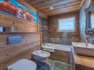This stunning bathroom boasts a unique blend of rustic charm and modern design.