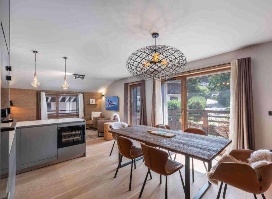 Experience luxury living in this stunning property, featuring a modern kitchen with a wine cooler and a spacious dining area.