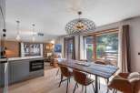 Experience luxury living in this stunning property, featuring a modern kitchen with a wine cooler and a spacious dining area.