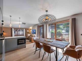 Experience luxury living in this stunning property, featuring a modern kitchen with a wine cooler and a spacious dining area.