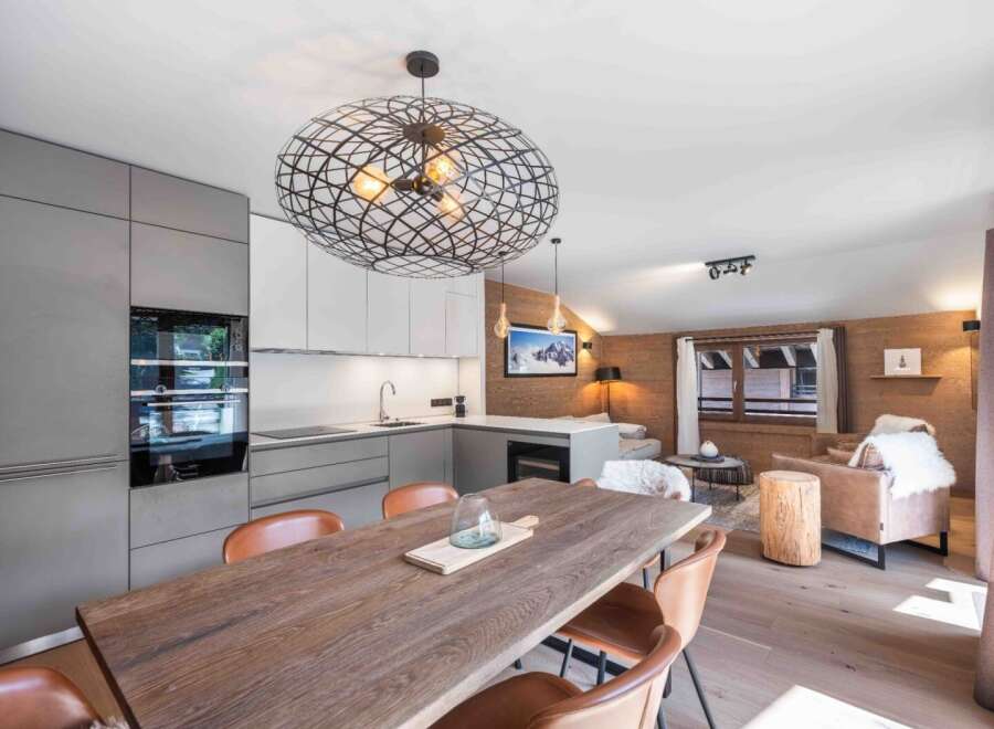 Experience luxury living in this stunning property, featuring a modern kitchen with sleek cabinetry and high-end appliances.