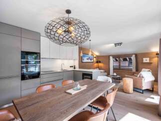 Experience luxury living in this stunning property, featuring a modern kitchen with sleek cabinetry and high-end appliances.